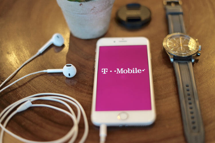 T Mobile on iPhone with Headphones and Watch